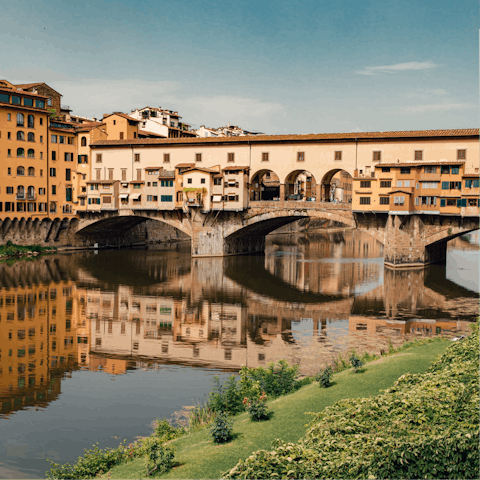 Walk across the historic Ponte Vecchio nearby