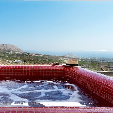 Unwind with a dip in the jacuzzi, looking out to the Aegean Sea