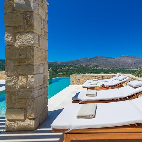 Soak up the sun on the comfy loungers on the side of the glistening pool