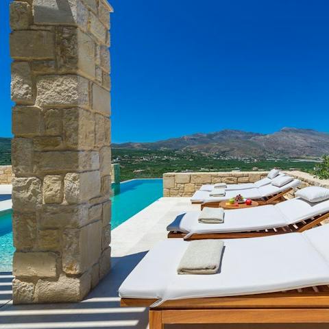 Soak up the sun on the comfy loungers on the side of the glistening pool