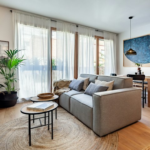 Enjoy a light-filled living room courtesy of floor to ceiling windows