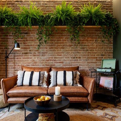 Chill out on the plant-framed sofa while listening to a record