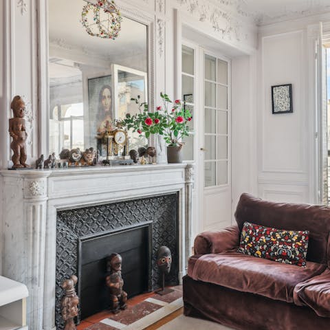 Curl up with a good book by the old marble fireplace