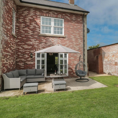 Enjoy an alfresco G&T in the  garden, admiring the views