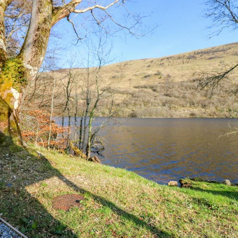 Watch the kingfishers and other wildlife around the loch next to this home
