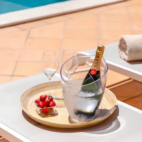 Sip champagne while lounging by the private pool