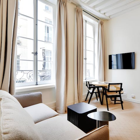 Perch by the living area's French windows with an evening glass of wine