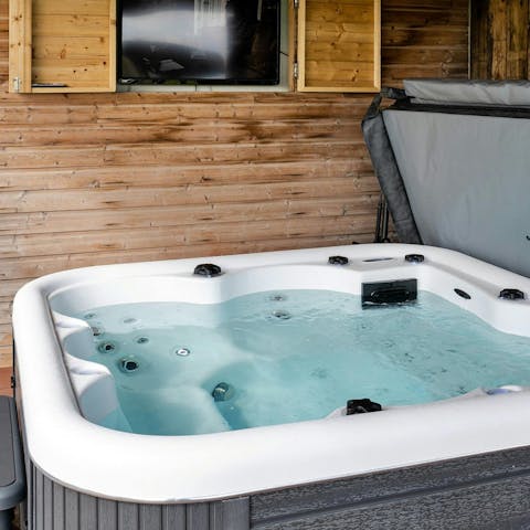 Unwind in the garden hot tub after a day exploring