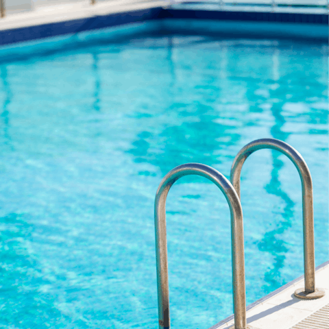 Plunge into your building's pristine pool for a refreshing start to your day