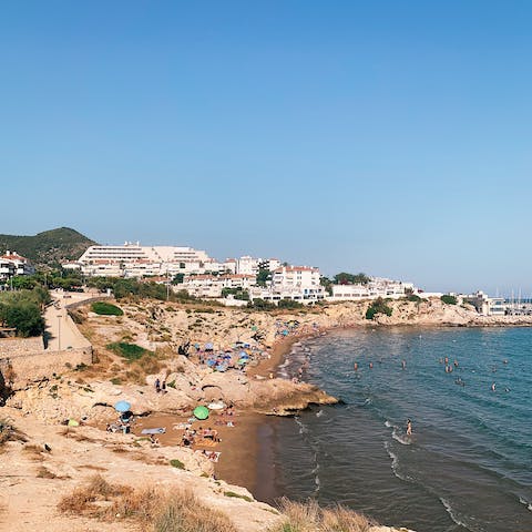 Drive twenty minutes to explore the golden sands of Sitges