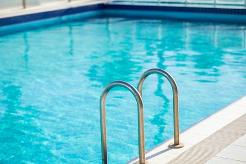 Cool off in the communal pool beneath clear San Diego skies