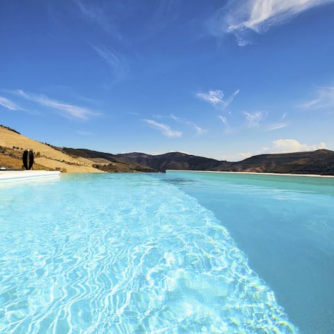 Lounge under the sun in the cool waters of the pool, overlooking breathtaking views of the valley