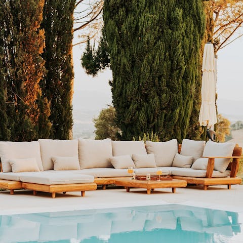 Welcome the evening with drinks by the pretty pool