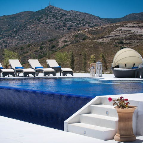Relax in your private pool and enjoy stunning views from this hilltop home