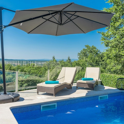 Stretch out by the pool surrounded by peaceful countryside