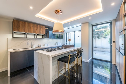 Cook and gather around the marble island in the light-filled kitchen