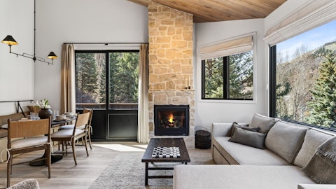 Warm up by the fire as pine forests frame the windows