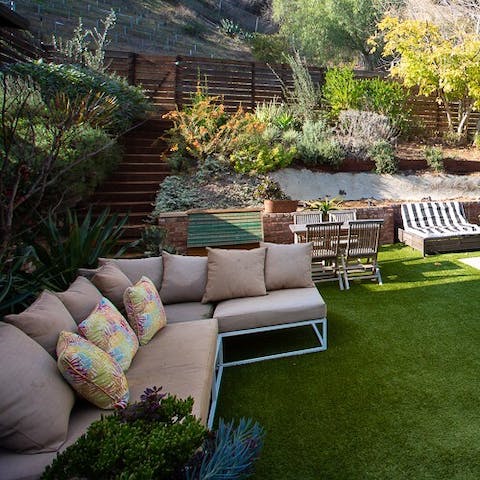 Unwind with drinks in the garden as the sun sets