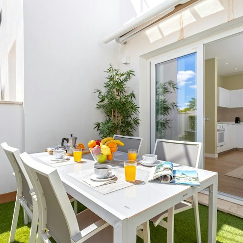 Tuck into plates of paella on the open-air table