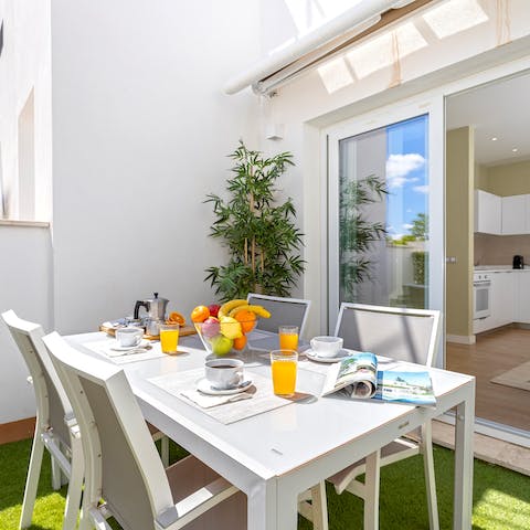 Tuck into plates of paella on the open-air table
