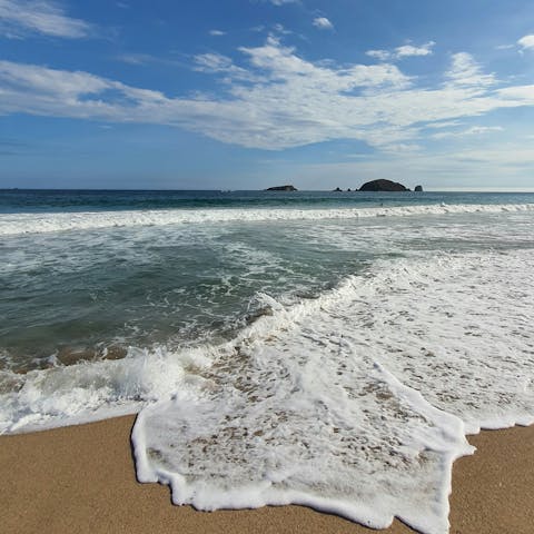 Stroll along the sand at Kalafati beach, a five-minute drive away