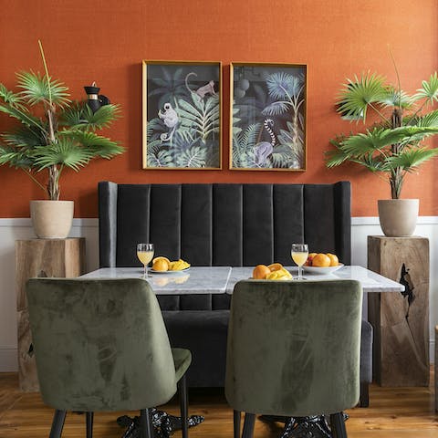 Sit down to an elegant meal at the marble and velvet dining set