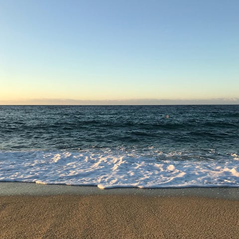 Sink your feet into the sand at Niu Blau beach