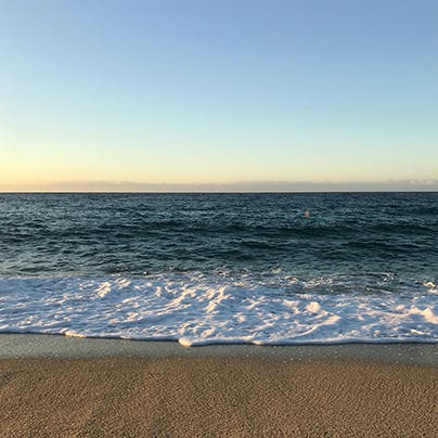Sink your feet into the sand at Niu Blau beach