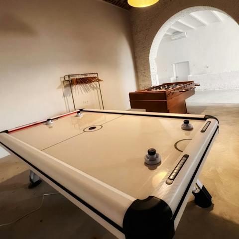 Get competitive on games night with table football and air hockey