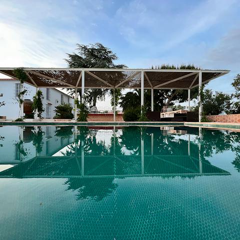 Float in the private pool under clear blue skies