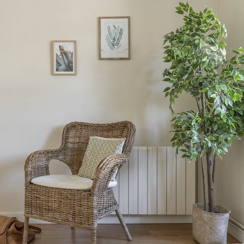 Snuggle up with a book and rest your feet on the wicker chair