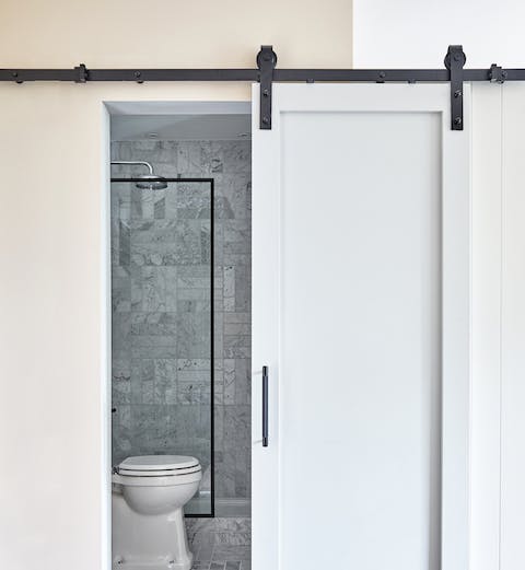 Take a long soak in the industrial-chic en-suite bathroom