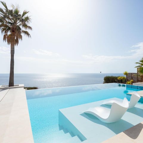 Soak in the private pool as you drink in the sea views