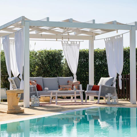 Enjoy cocktail hour by the pool in the private cabana