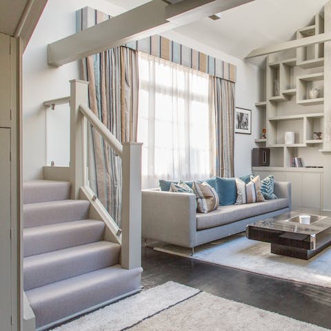 Admire the unique architecture and high ceilings of the huge living space