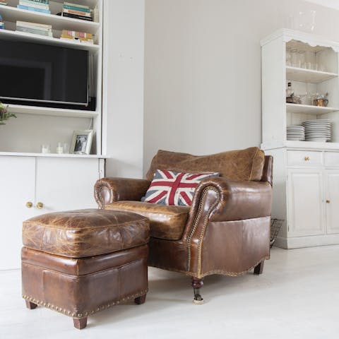 Relax in the brown leather armchair with a good book