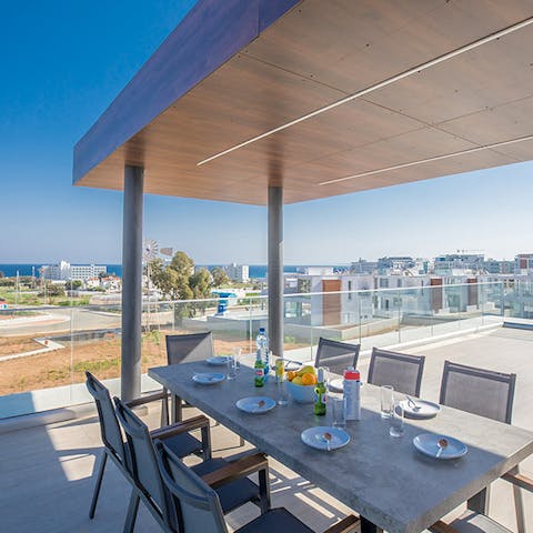 Gather upstairs on the rooftop terrace for scenic evening dinners with ocean views