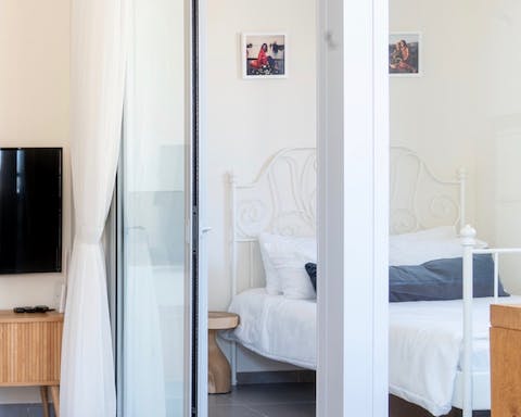Admire interesting design touches like the glass wall between bedroom and living room