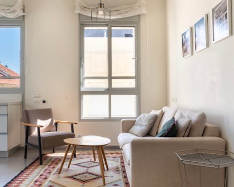 Relax in the living room as natural light streams in