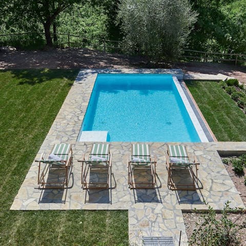 Lounge by the pool with a drink and a book