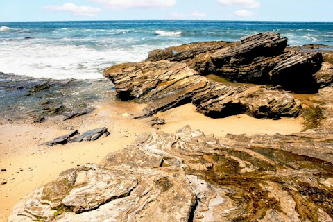 Hike Crystal Cove State Park's rugged coastal bluffs and pristine tidepools, roughly a thirty-minute drive