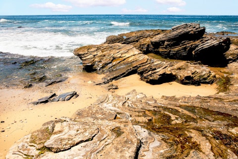 Hike Crystal Cove State Park's rugged coastal bluffs and pristine tidepools, roughly a thirty-minute drive