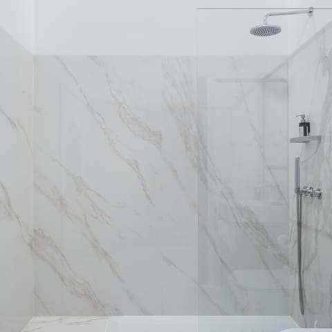 Relax and unwind under the marble bathroom's rainfall shower