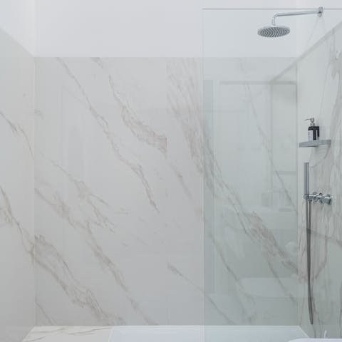 Relax and unwind under the marble bathroom's rainfall shower