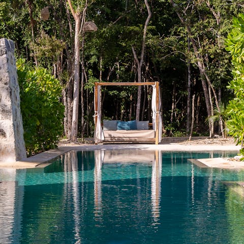 Feel zen as you lay poolside among the lush greenery