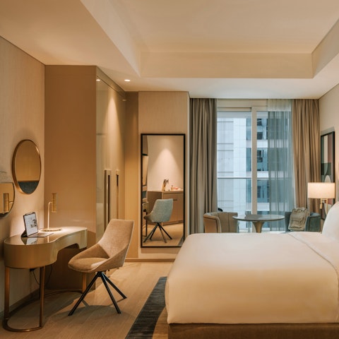 Sip coffee while working remotely at this elegant desk space in your well-lit suite