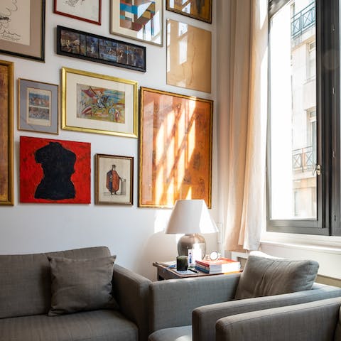 Watch how light streams through the large windows illuminating the impressive gallery wall