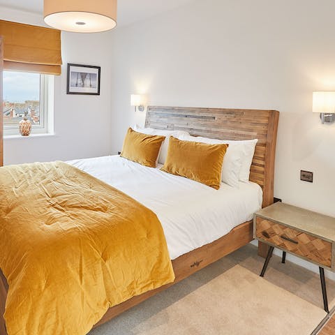 Have a rest in the comfy bed with its gold velvet throw