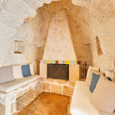 Curl up the cosy living area by the open fireplace