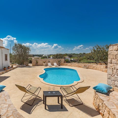 Share a bottle of local wine by the private outdoor pool